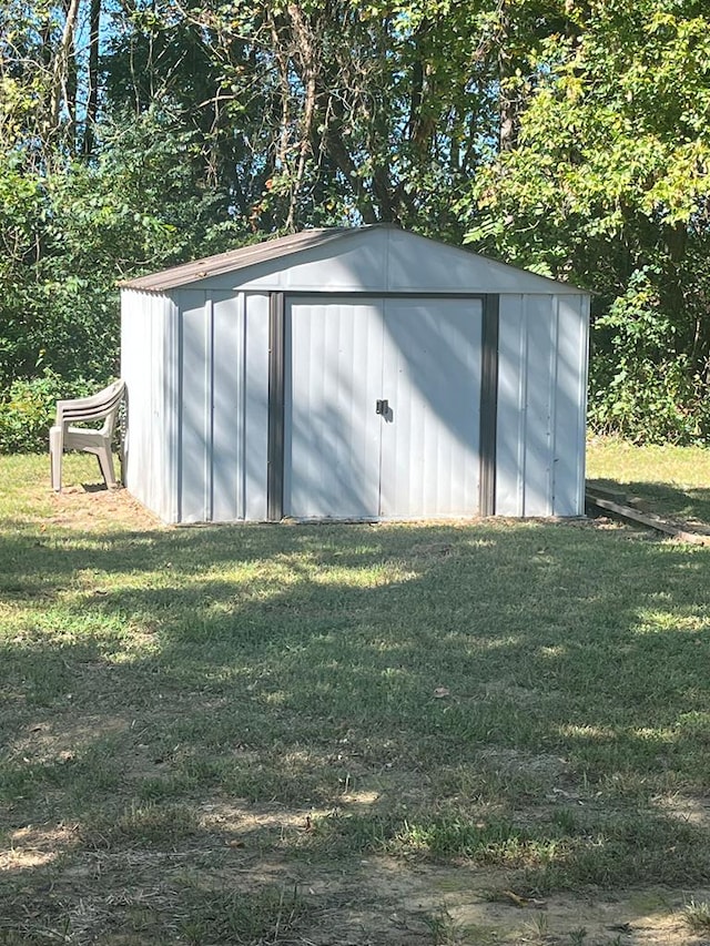 view of outbuilding with a lawn