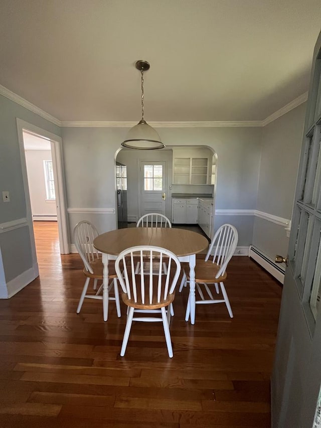 dining space with ornamental molding, a baseboard radiator, and dark wood-type flooring