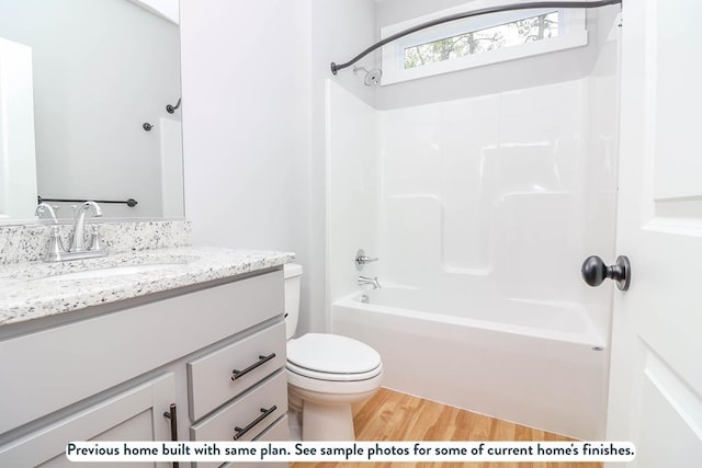 full bathroom with vanity, toilet, wood-type flooring, and shower / tub combination