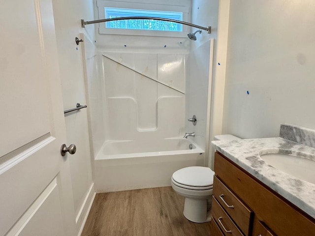 bathroom with vanity, toilet, shower / bathtub combination, and wood finished floors