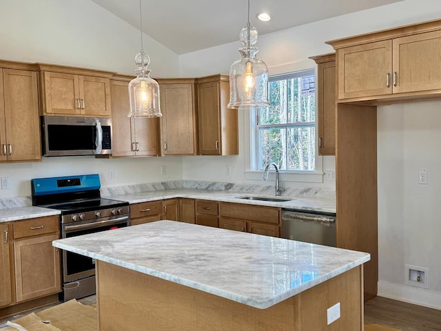 kitchen with a kitchen island, lofted ceiling, a sink, stainless steel appliances, and pendant lighting