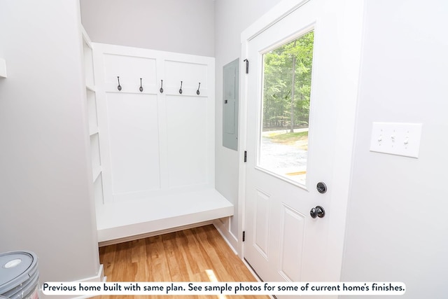 mudroom featuring electric panel and light wood finished floors