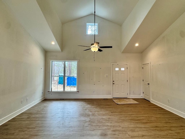 entryway with high vaulted ceiling, a ceiling fan, baseboards, and wood finished floors