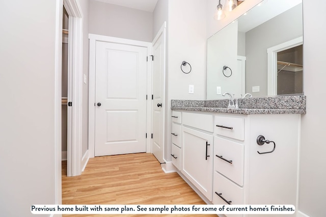 bathroom featuring vanity and wood-type flooring