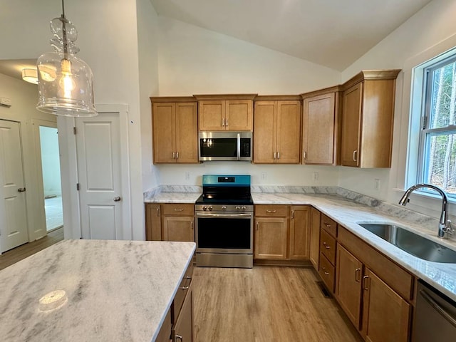 kitchen featuring a sink, brown cabinetry, and stainless steel appliances