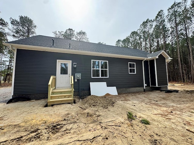 back of property featuring entry steps