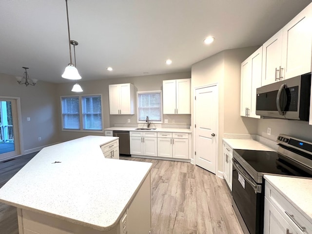 94 Dingley Rd, Va, VA 22520 - kitchen featuring appliances with stainless steel finishes, light wood finished floors, a kitchen island, white cabinets, and recessed lighting