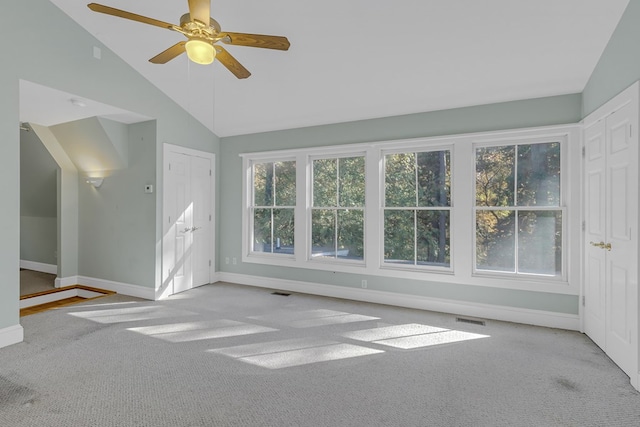 interior space featuring lofted ceiling, light colored carpet, and ceiling fan