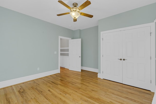 unfurnished bedroom with a closet, ceiling fan, and light wood-type flooring