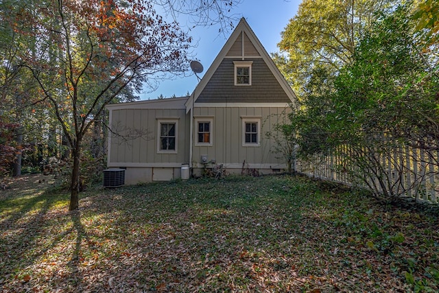 view of property exterior with central AC unit and a lawn