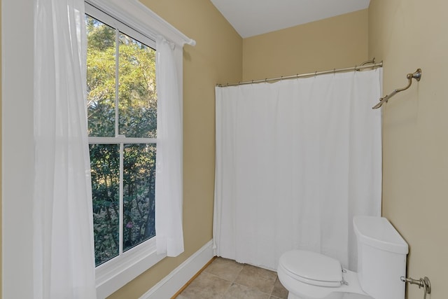 bathroom with tile patterned flooring and toilet