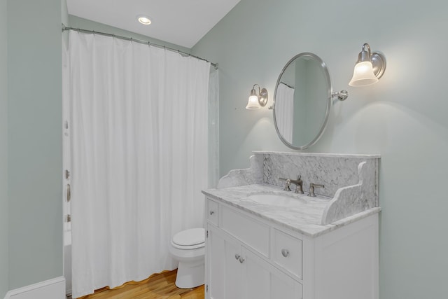 bathroom with hardwood / wood-style flooring, vanity, and toilet