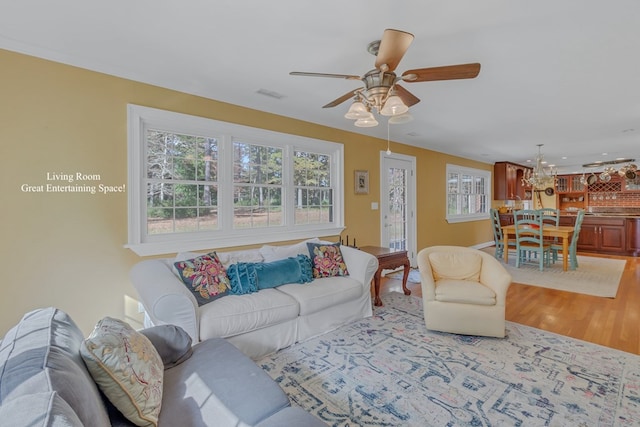 living room with ceiling fan and light hardwood / wood-style floors