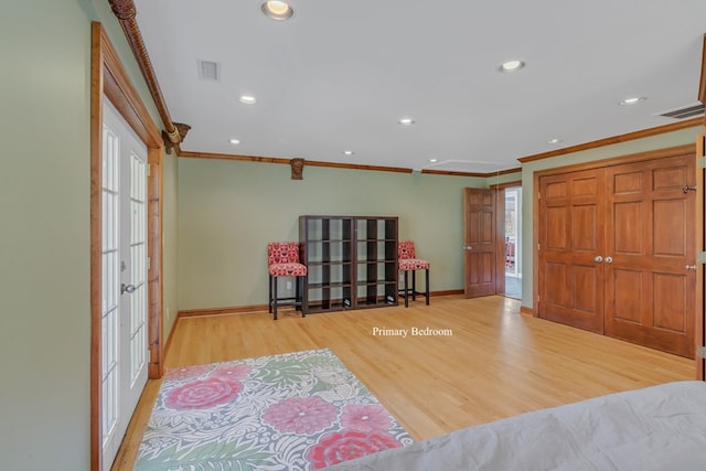 interior space with french doors, light hardwood / wood-style floors, and ornamental molding