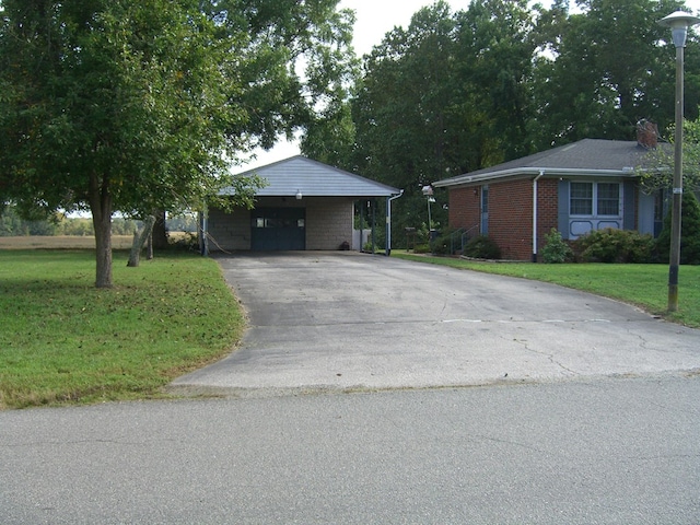 ranch-style house featuring a front yard and a carport