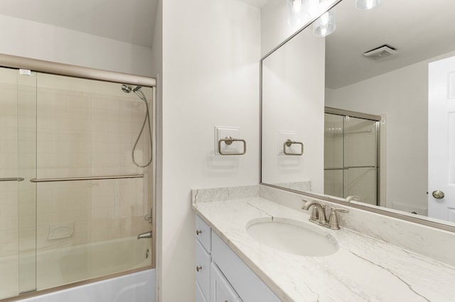 217 Kilmer Point Dr, Urbanna, VA 23175 - bathroom with combined bath / shower with glass door, visible vents, and vanity