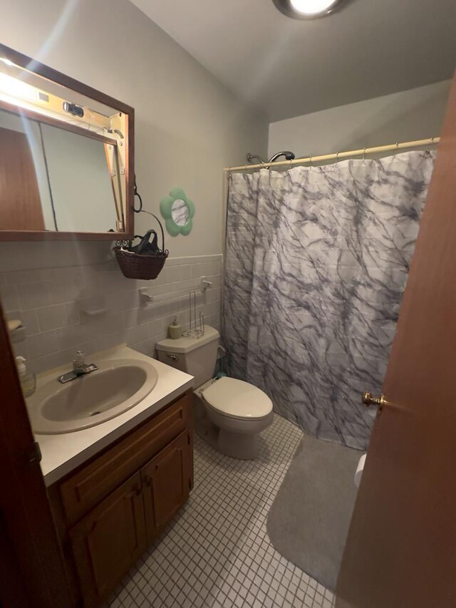 203 Lampkintown Rd, Burgess, VA 22432 - full bath with vanity, toilet, tile patterned floors, curtained shower, and tile walls