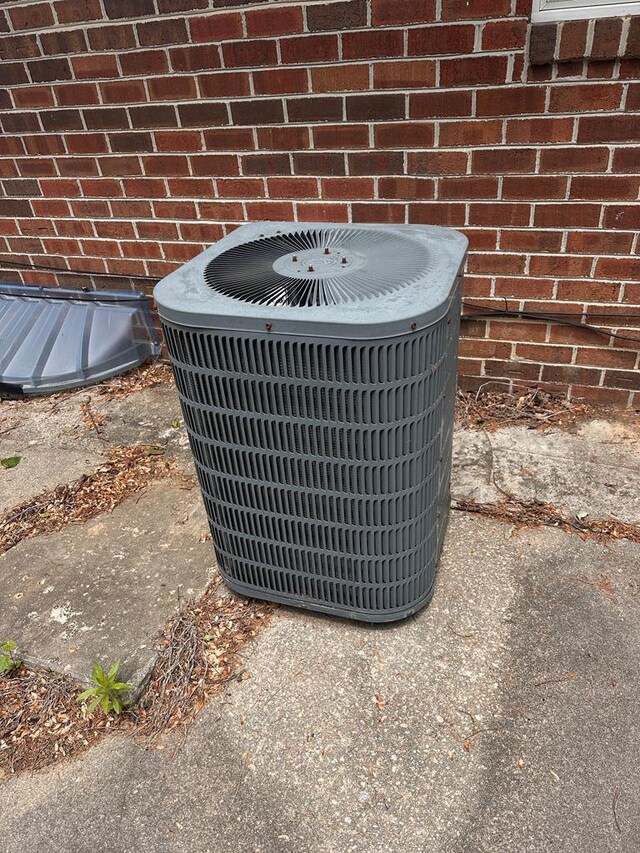203 Lampkintown Rd, Burgess, VA 22432 - exterior view of cooling unit and brick siding