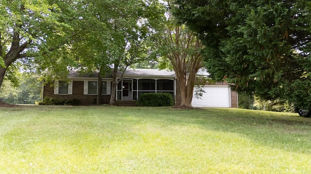 203 Lampkintown Rd, Burgess, VA 22432 - view of front of house with a garage, a front lawn, brick siding, and a sunroom