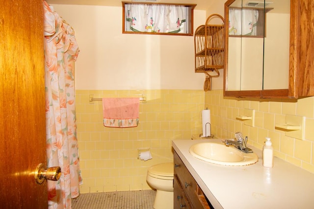 203 Lampkintown Rd, Burgess, VA 22432 - full bathroom featuring vanity, toilet, a shower with curtain, tile walls, and wainscoting