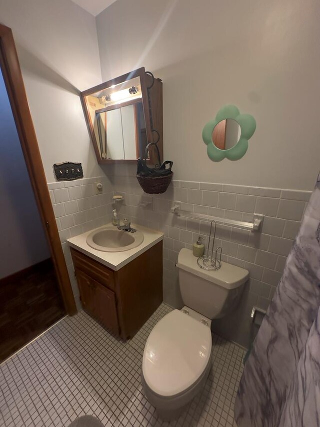 203 Lampkintown Rd, Burgess, VA 22432 - bathroom featuring tile walls, vanity, wainscoting, toilet, and tile patterned floors