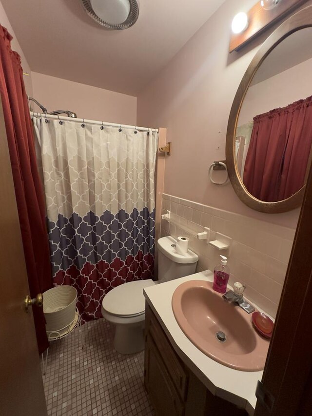 203 Lampkintown Rd, Burgess, VA 22432 - bathroom with vanity, tile patterned flooring, toilet, wainscoting, and tile walls