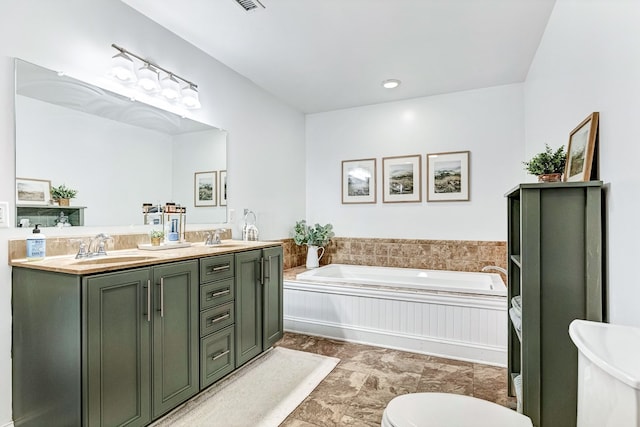 full bath featuring a bath, double vanity, toilet, and a sink