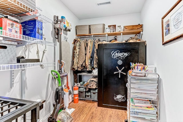 walk in closet with visible vents and wood finished floors