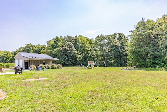 view of yard featuring an outdoor structure and a playground