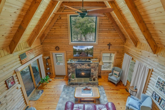 living room with beam ceiling, light wood-type flooring, high vaulted ceiling, and wooden ceiling