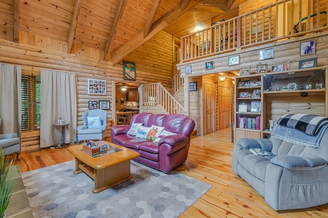 living room with hardwood / wood-style floors, high vaulted ceiling, rustic walls, and wood ceiling