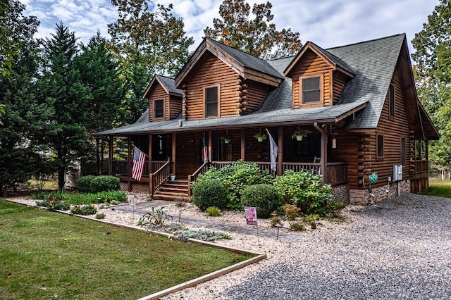 log home with a front lawn and a porch