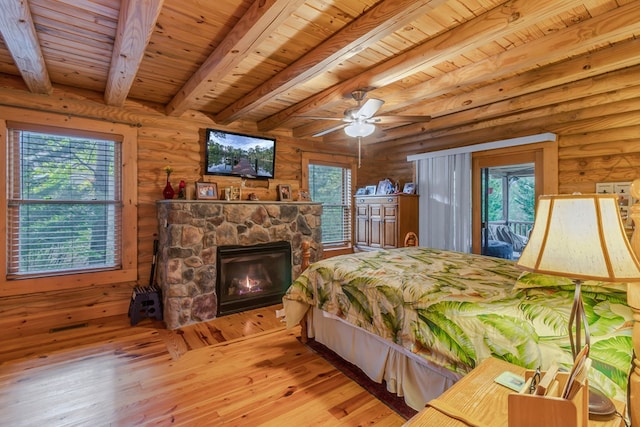 bedroom with beam ceiling, ceiling fan, log walls, light hardwood / wood-style flooring, and wood ceiling