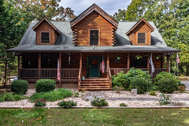 log cabin featuring covered porch