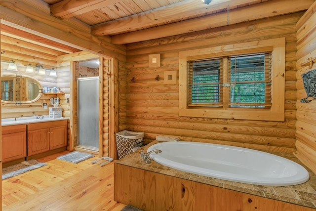 bathroom with hardwood / wood-style floors, log walls, wooden ceiling, and beamed ceiling