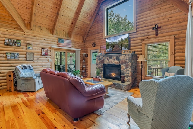 living room featuring high vaulted ceiling, light wood-type flooring, a fireplace, rustic walls, and beamed ceiling