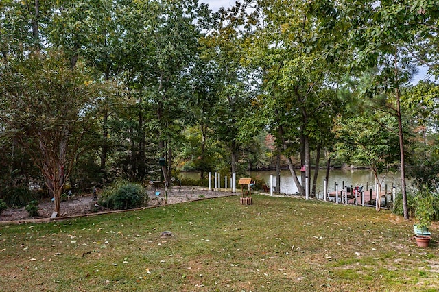 view of yard with a boat dock and a water view