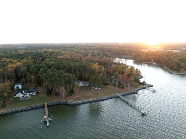 aerial view at dusk featuring a water view