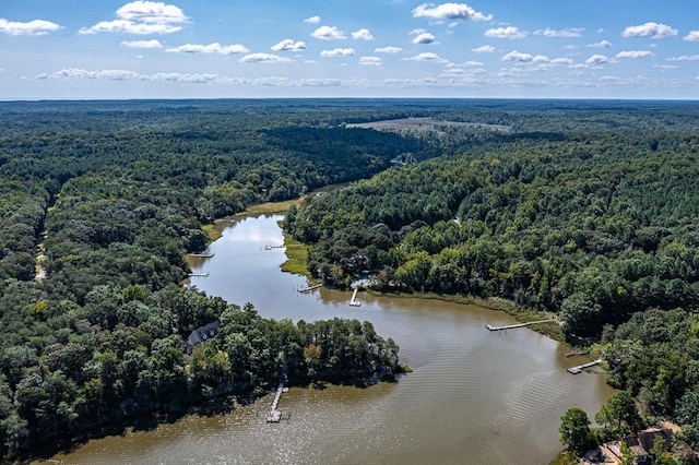 aerial view with a wooded view and a water view