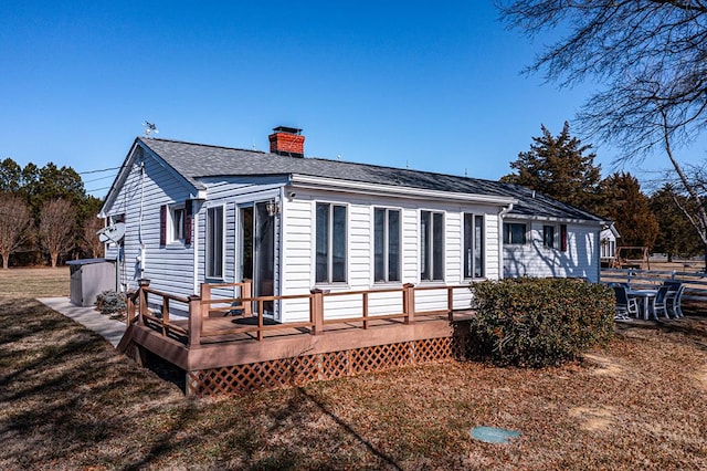 rear view of house with a wooden deck