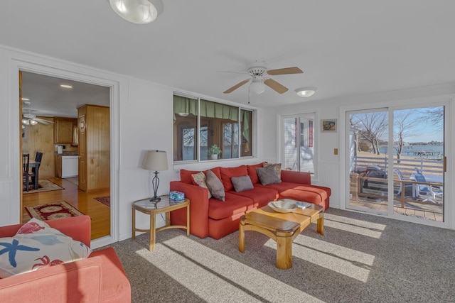 living room featuring ceiling fan and carpet flooring