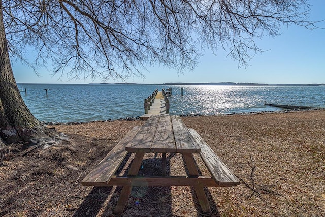 view of property's community with a water view and a boat dock