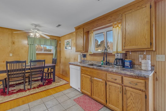 kitchen featuring a wealth of natural light, white dishwasher, light tile patterned floors, and sink