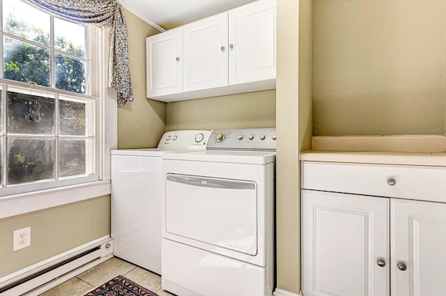 washroom with cabinets, light tile patterned floors, washing machine and dryer, and baseboard heating