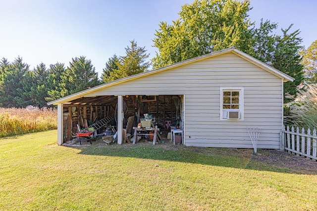 view of outbuilding featuring a yard and cooling unit