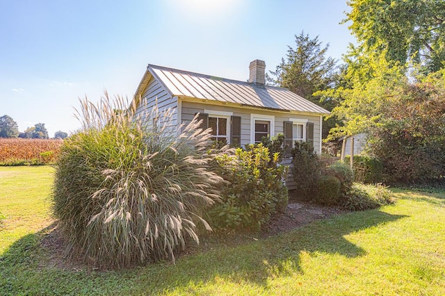 view of property exterior with a yard