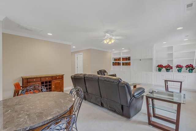 living room featuring visible vents, a ceiling fan, crown molding, recessed lighting, and light carpet