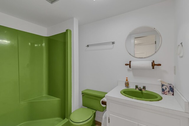 full bathroom with toilet, a walk in shower, vanity, and visible vents