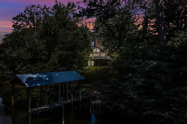 yard at dusk featuring a boat dock