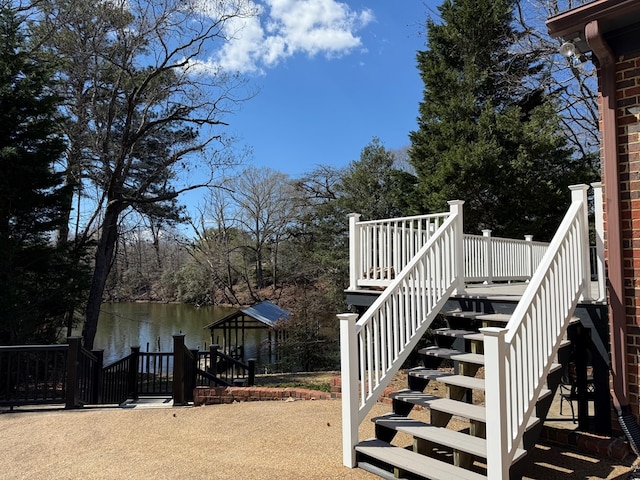 exterior space with a water view and stairs